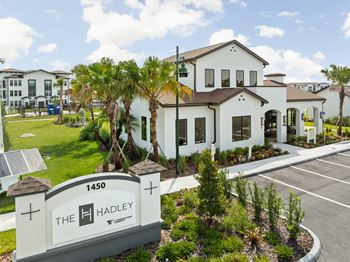 The Hadley sign is in front of a white building  at The Hadley - North Port, FL Apartments, North Port 34287